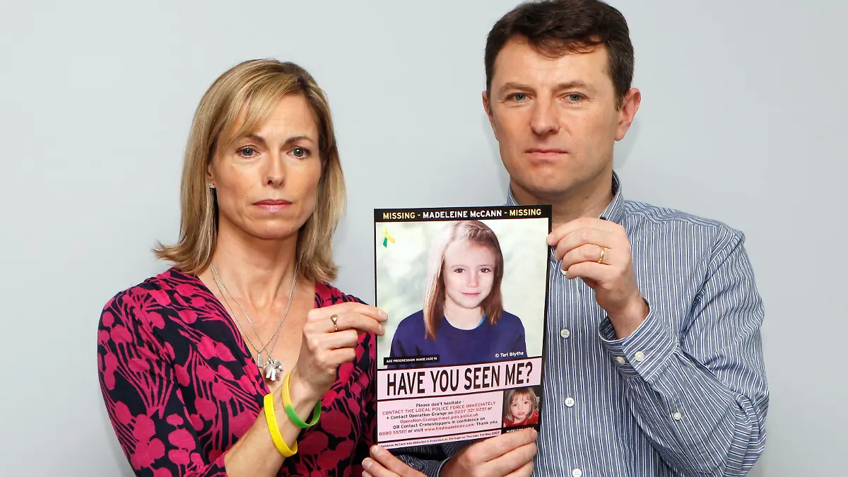 FILE PHOTO: Kate and Gerry McCann pose with a computer generated image of how their missing daughter Madeleine might look now, during a news conference in London May 2, 2012. REUTERS/Andrew Winning/File Photo