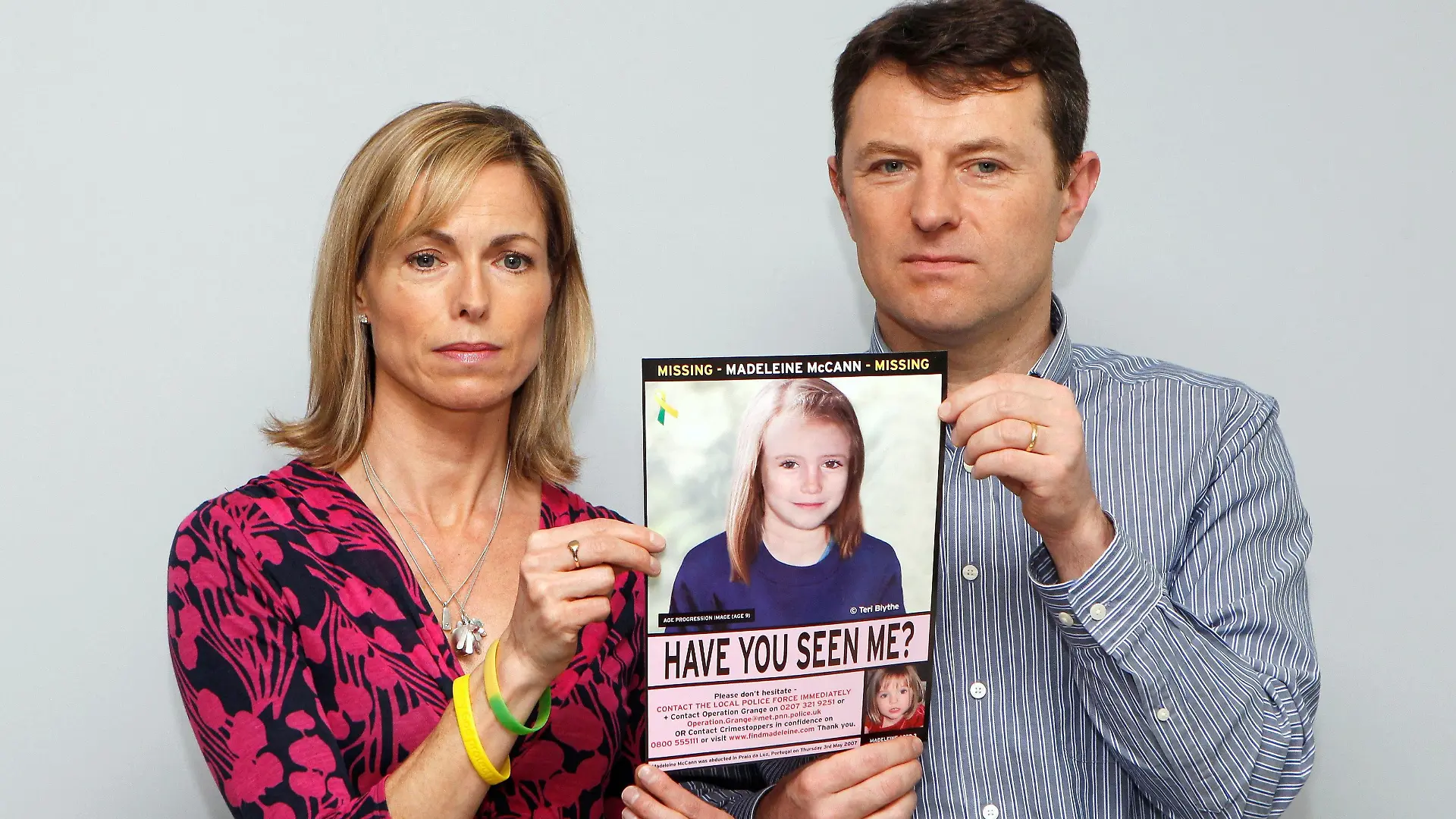 FILE PHOTO: Kate and Gerry McCann pose with a computer generated image of how their missing daughter Madeleine might look now, during a news conference in London May 2, 2012. REUTERS/Andrew Winning/File Photo