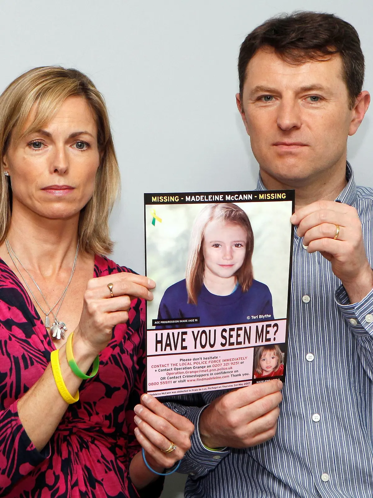 FILE PHOTO: Kate and Gerry McCann pose with a computer generated image of how their missing daughter Madeleine might look now, during a news conference in London May 2, 2012. REUTERS/Andrew Winning/File Photo