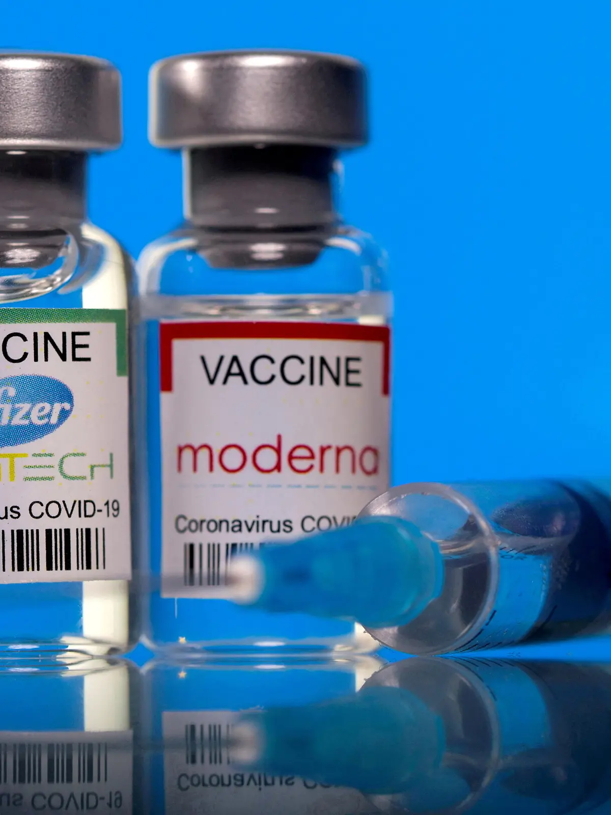 FILE PHOTO: Vials with Pfizer-BioNTech and Moderna coronavirus disease (COVID-19) vaccine labels are seen in this illustration picture taken March 19, 2021. REUTERS/Dado Ruvic/Illustration//File Photo