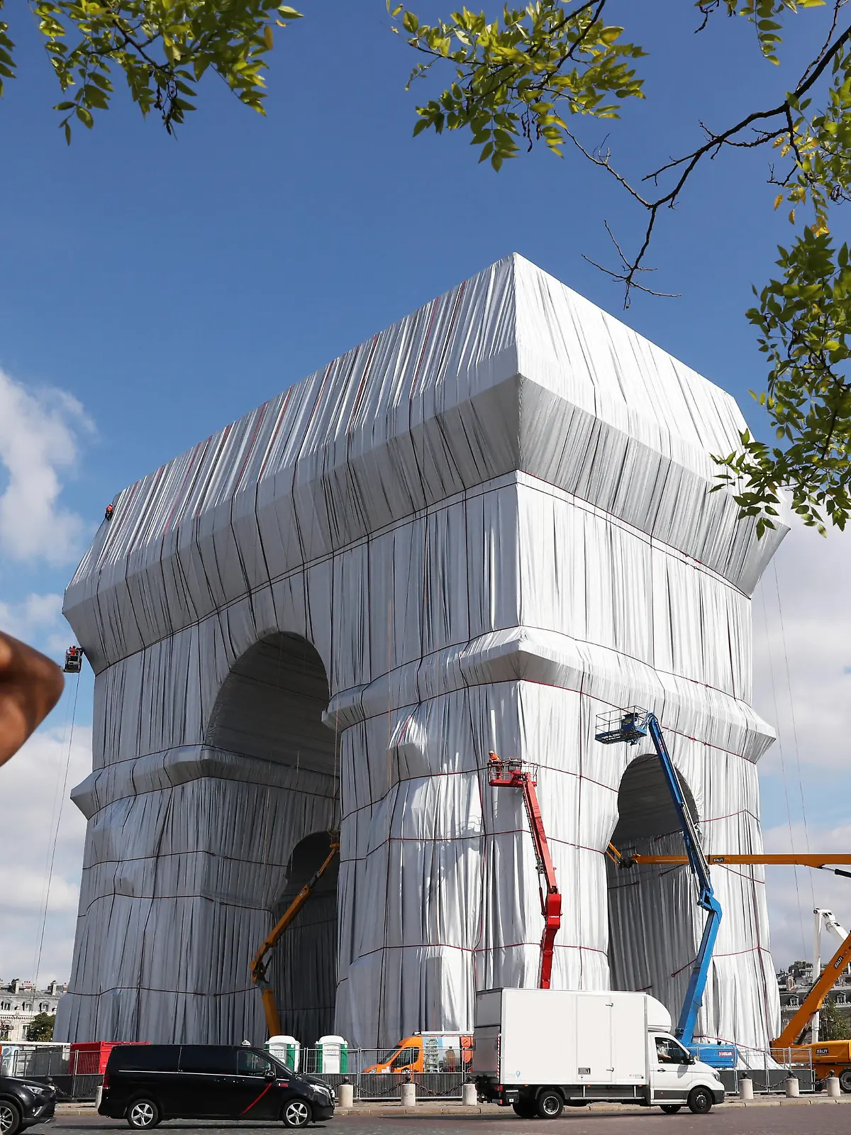  210916 -- PARIS, Sept. 16, 2021 -- A man takes photos of the wrapped Arc de Triomphe before an inauguration in Paris, France, on Sept. 16, 2021. The entire Arc de Triomphe at the top of the Champs-Elysees in Paris is to stay wrapped in fabric for two weeks, an art installation conceived by the late artist Christo and inaugurated on Thursday by French President Emmanuel Macron. The 50-meter high, 45-meter long and 22-meter wide monument built by Napoleon, is now wrapped head to toe in 25,000 square metres of recyclable silvery-blue fabric and 3,000 meters of red rope.  FRANCE-PARIS-ARC DE TRIOMPHE-FABRIC-WRAPPING GaoxJing PUBLICATIONxNOTxINxCHN