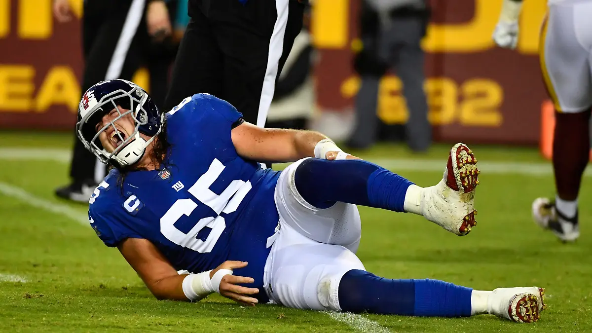Sep 16, 2021; Landover, Maryland, USA; New York Giants center Nick Gates (65) reacts after suffering an apparent leg injury against the Washington Football Team during the first half at FedExField. Mandatory Credit: Brad Mills-USA TODAY Sports