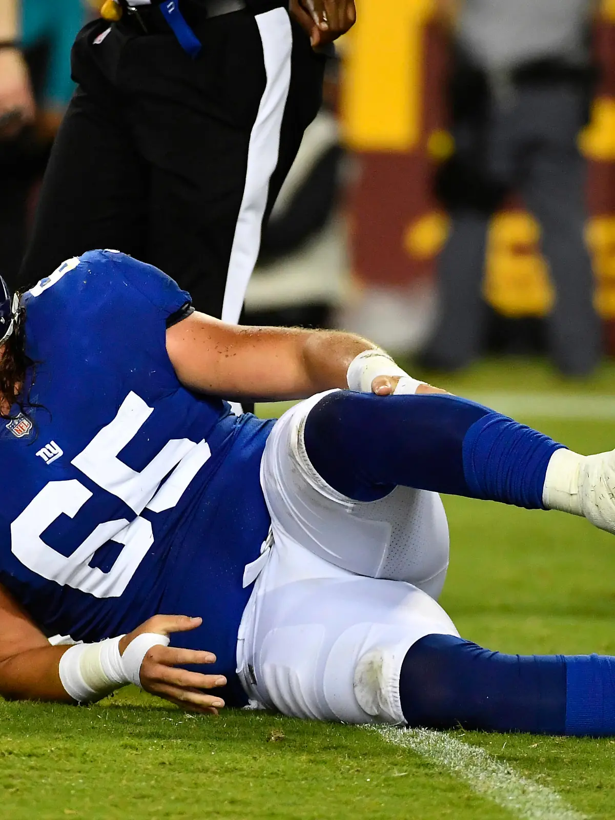 Sep 16, 2021; Landover, Maryland, USA; New York Giants center Nick Gates (65) reacts after suffering an apparent leg injury against the Washington Football Team during the first half at FedExField. Mandatory Credit: Brad Mills-USA TODAY Sports