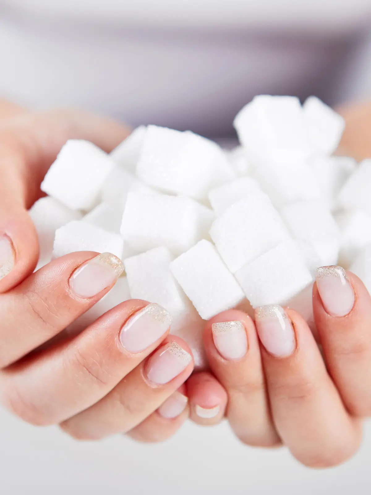 Woman holds in hands of sugar cubes
