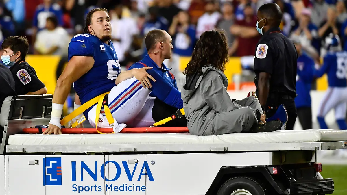 Sep 16, 2021; Landover, Maryland, USA; New York Giants center Nick Gates (65) reacts after suffering an apparent leg injury against the Washington Football Team during the first half at FedExField. Mandatory Credit: Brad Mills-USA TODAY Sports