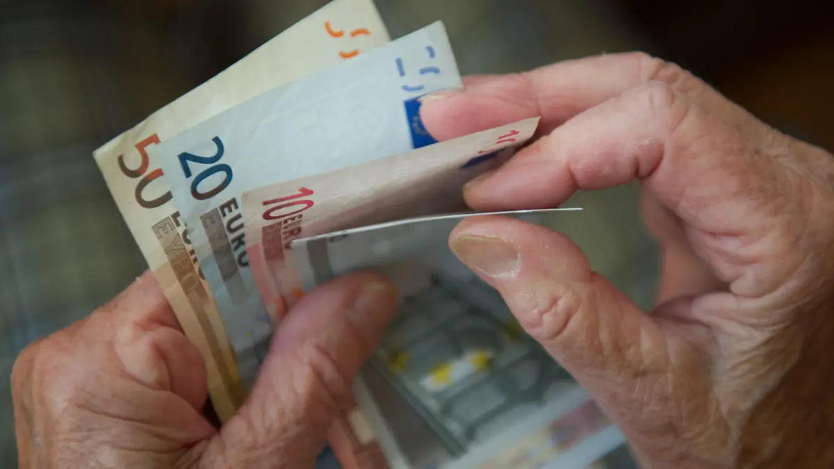 ARCHIV - 26.06.2012, Baden-Württemberg, Stuttgart: Eine ältere Frau zählt Geld. Die Chefs der Wirtschaftsforschungsinstitute DIW und IW fordern, dass die geplante Energiepreispauschale in Höhe von 300 Euro auch für Rentner gilt. (zu dpa: «Ökonomen fordern: Energiepauschale auch für Rentner») Foto: Marijan Murat/dpa +++ dpa-Bildfunk +++