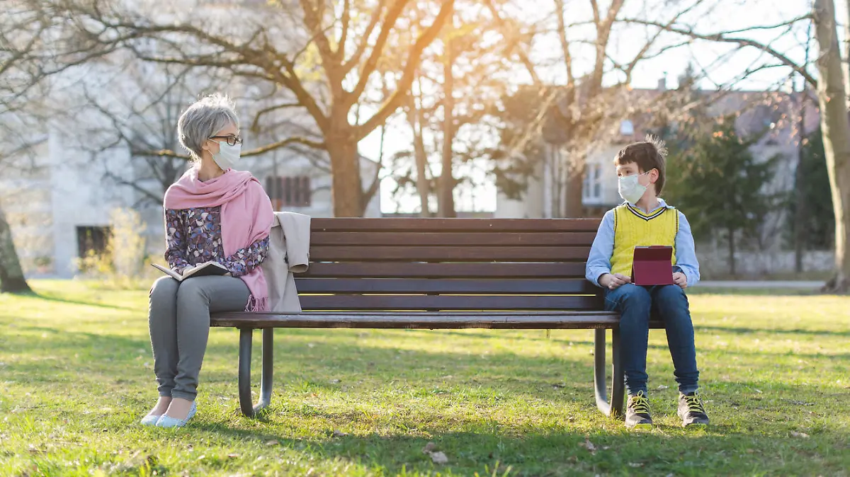 Grandmother and grandson separated by social distancing