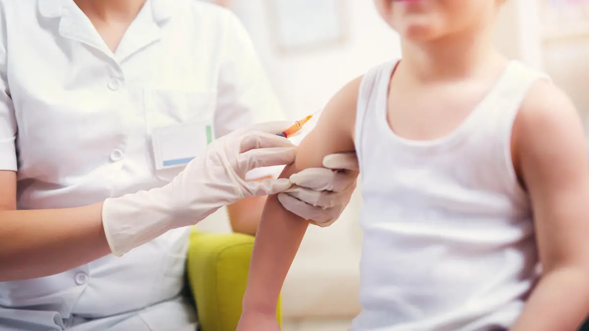 Pediatrician makes vaccination to small boy