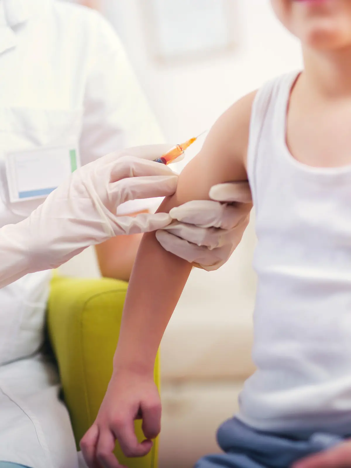 Pediatrician makes vaccination to small boy