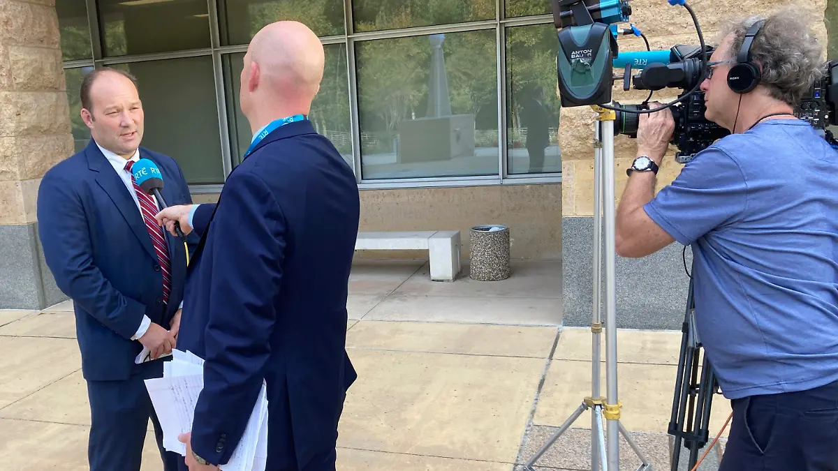 A reporter interviews acting U.S. Attorney Jonathan Lenzner outside the federal courthouse in Greenbelt, Md., on Wednesday, Sept. 15, 2021, after a judge sentenced Eric Eoin Marques to 27 years in prison. U.S. authorities have said Marques, 36, was the world's most prolific purveyor of child pornography when he was arrested in Ireland in 2013. (AP Photo/Michael Kunzelman)