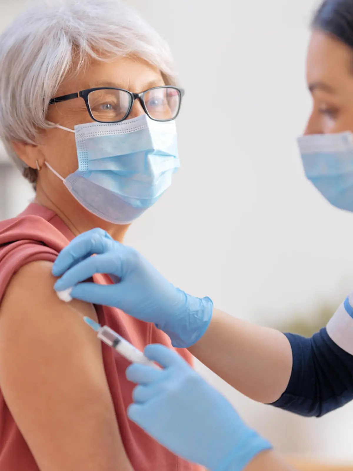 Doctor vaccinating a senior woman. Virus protection. COVID-2019.