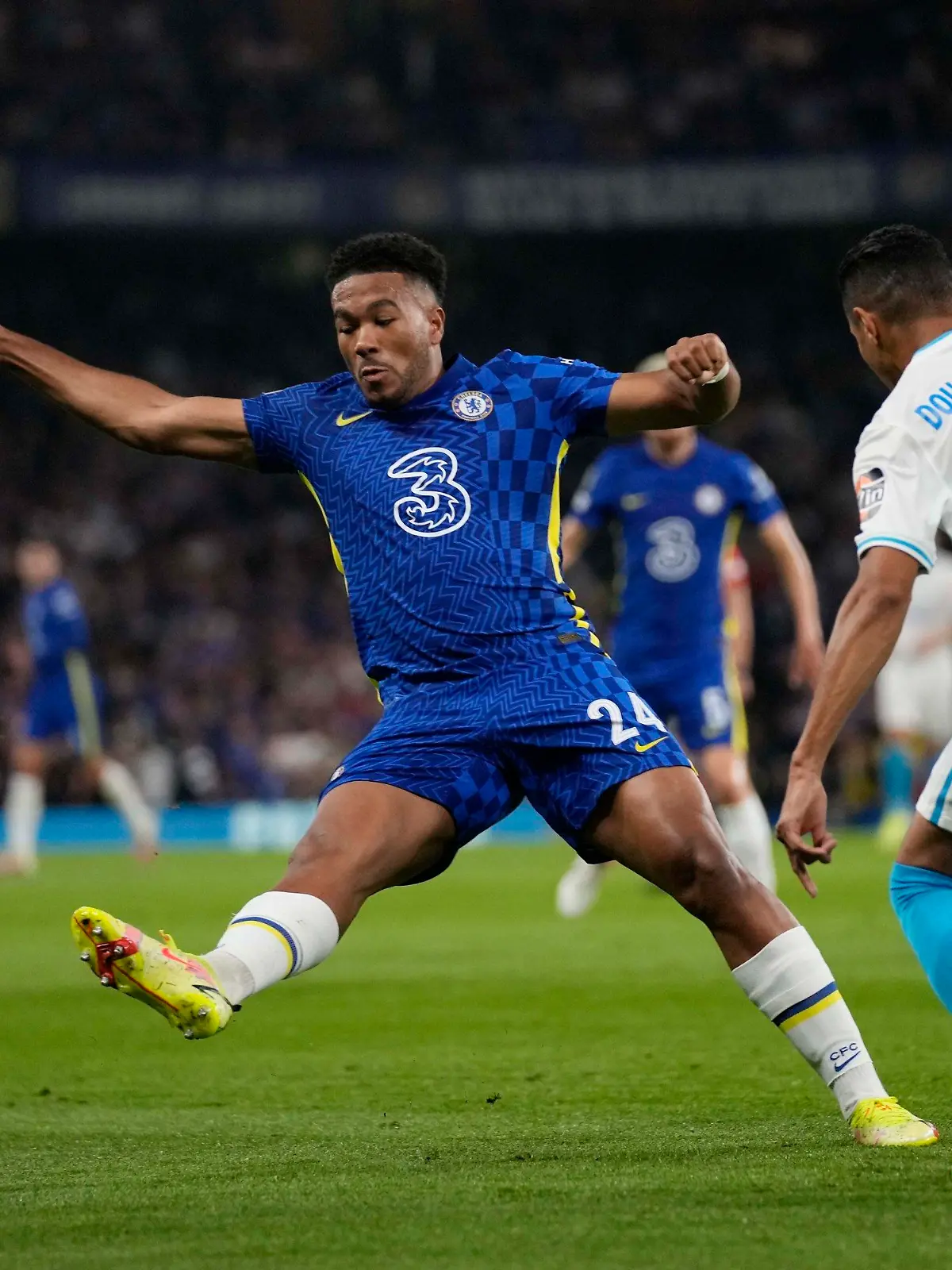 Chelsea's Reece James, left, challenges for the ball with Zenit's Douglas Santos during the Champions League Group H soccer match between Chelsea and Zenit St Petersburg at Stamford Bridge stadium in London Tuesday, Sept. 14, 2021. (AP Photo/Kirsty Wigglesworth)