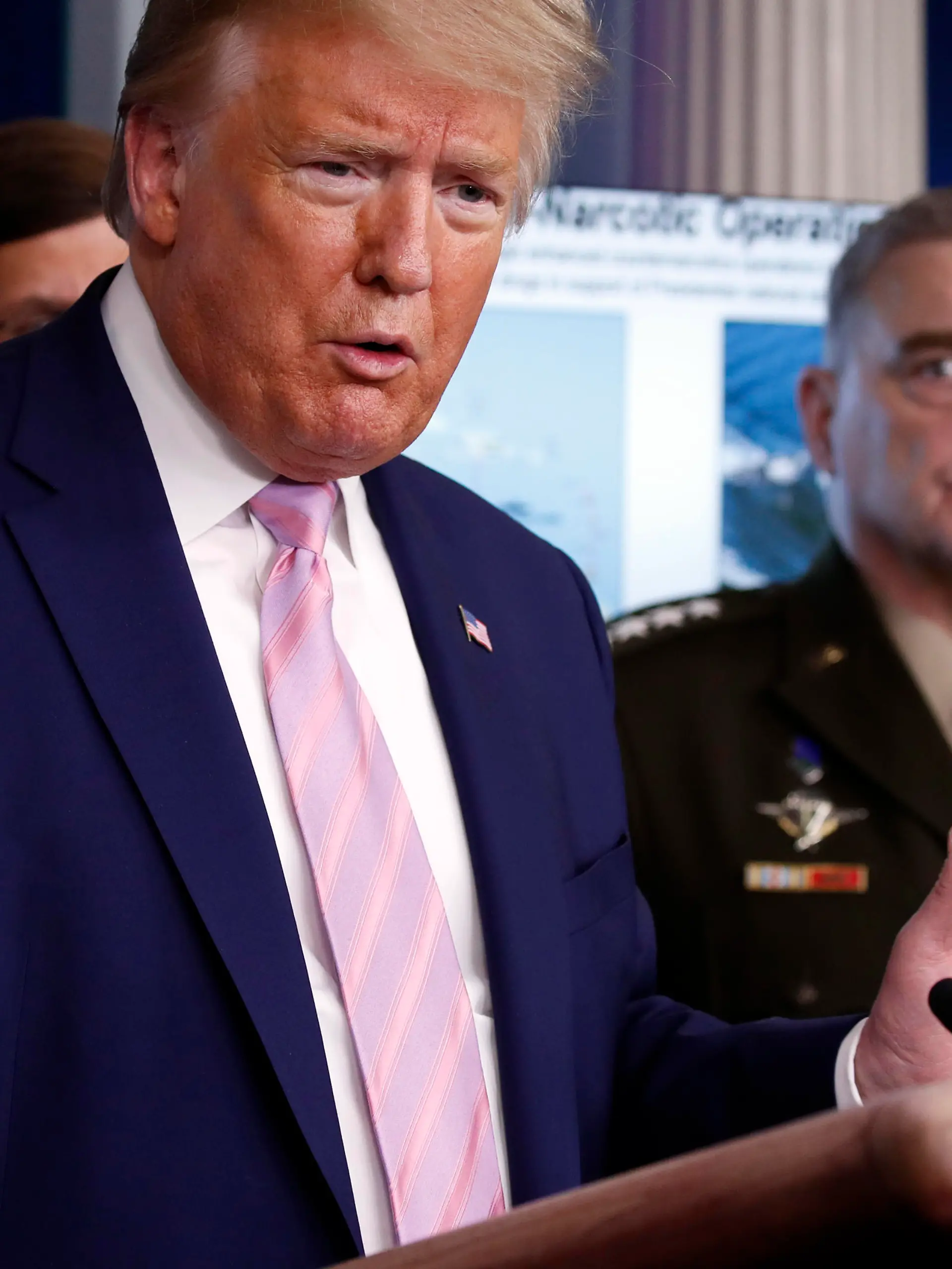 President Donald Trump speaks about the coronavirus in the James Brady Press Briefing Room of the White House, Wednesday, April 1, 2020, in Washington, as Chairman of the Joint Chiefs Gen. Mark Milley, listens. (AP Photo/Alex Brandon)