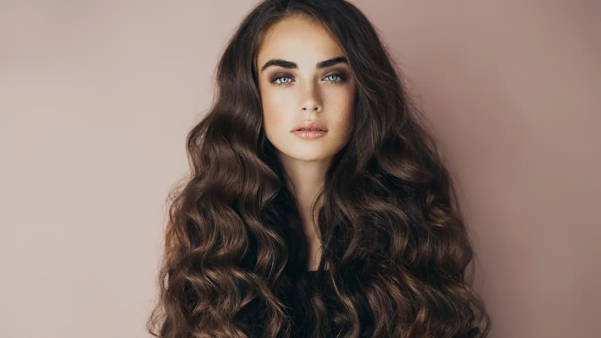 Studio shot of young beautiful woman. Professional make-up and hairstyle.