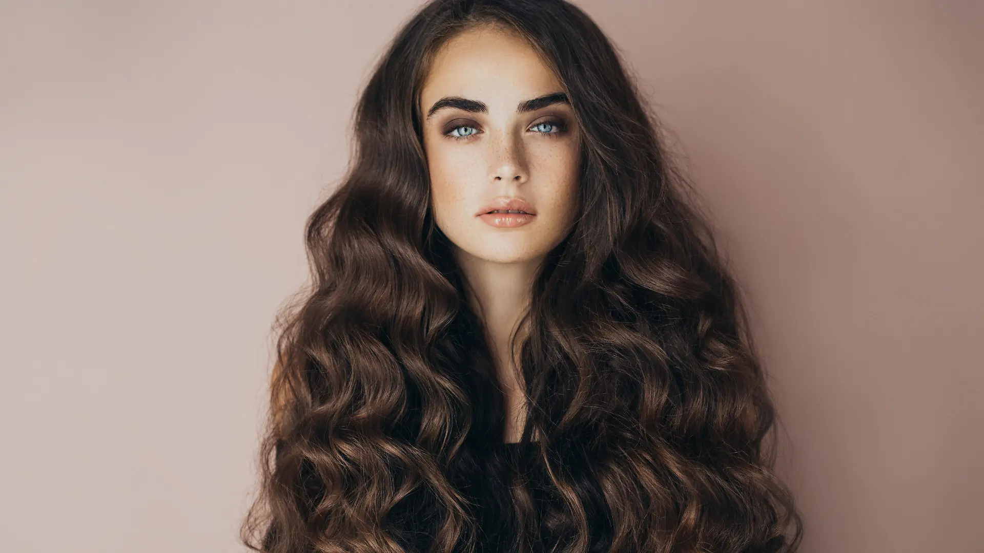 Studio shot of young beautiful woman. Professional make-up and hairstyle.