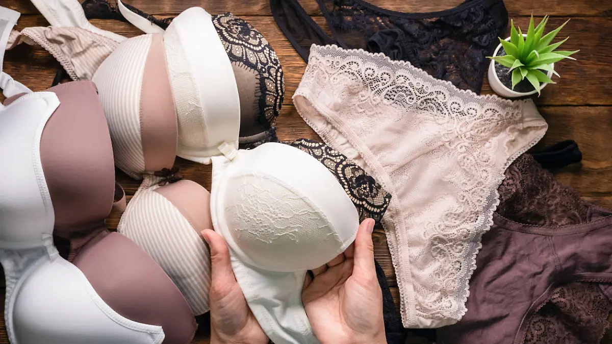 Woman is choosing a new underwear in a lingerie shop.
