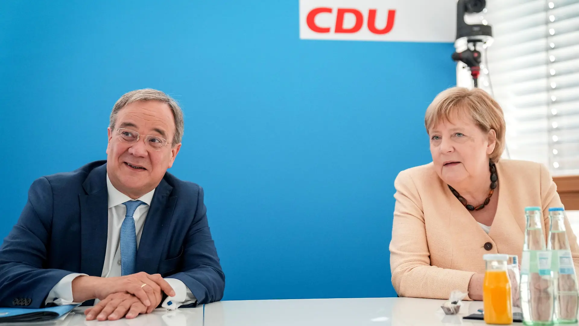 North Rhine-Westphalia State Prime Minister, Christian Democratic Union (CDU) leader and candidate for chancellor Armin Laschet and German Chancellor Angela Merkel talk before a CDU leadership meeting in Berlin, Germany, September 13, 2021. Kay Nietfeld/Pool via REUTERS