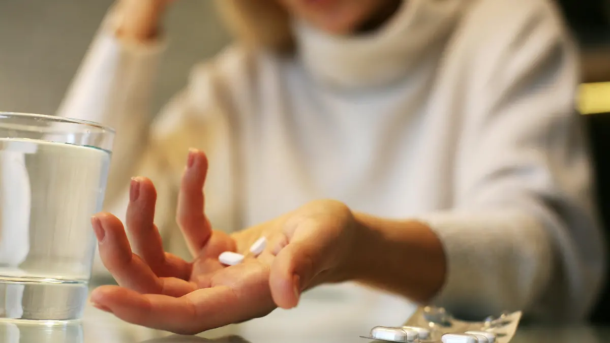 Close up of woman hands holding a pills.