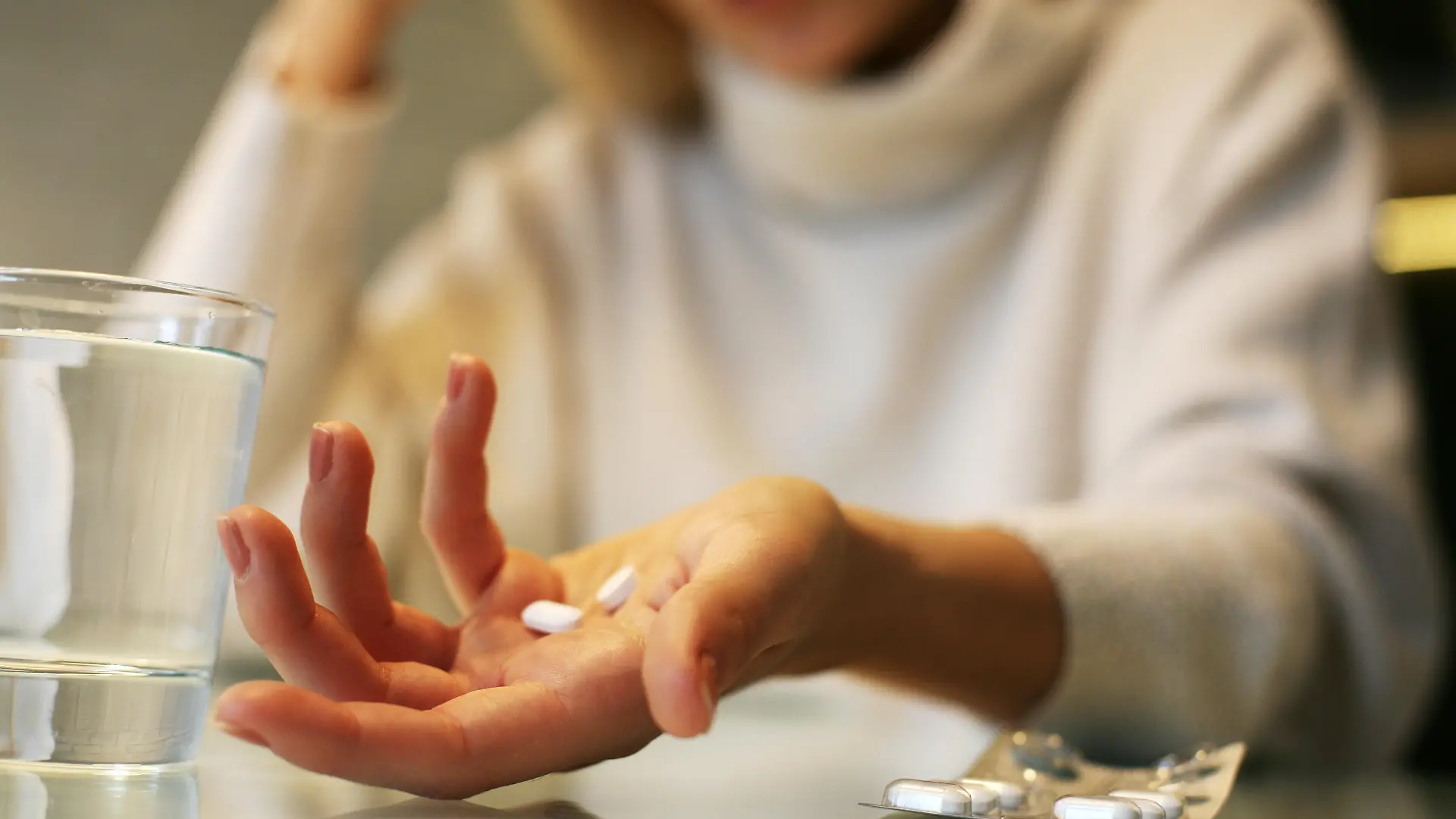 Close up of woman hands holding a pills.