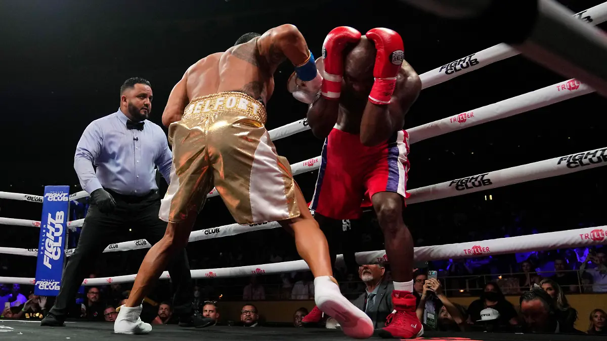 Former heavyweight champion Evander Holyfield, right, shields himself from punches by former MMA star Vitor Belfort, before the boxing bout was stopped in the first round Saturday, Sept. 11, 2021, in Hollywood, Fla. (AP Photo/Rebecca Blackwell)