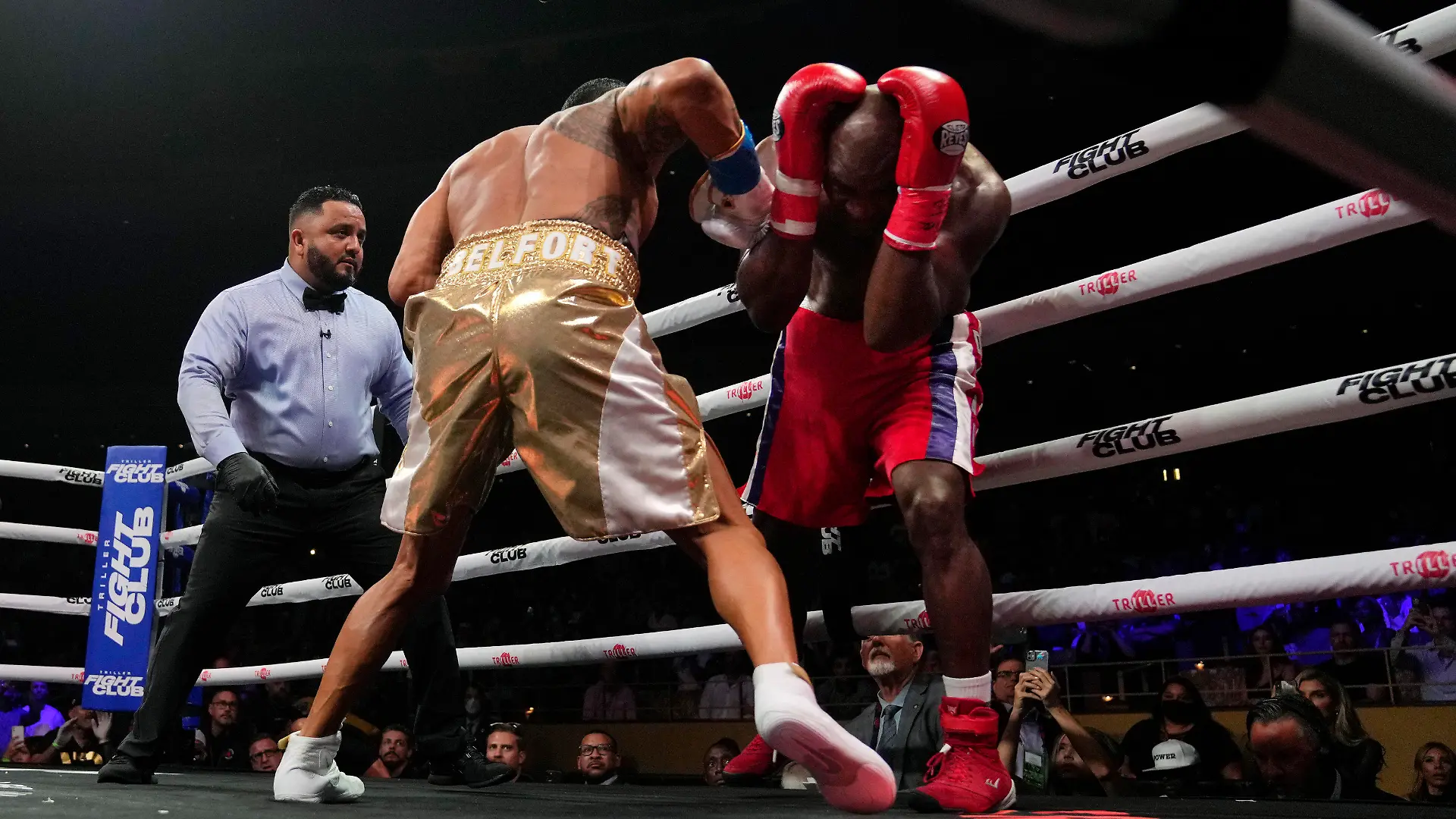 Former heavyweight champion Evander Holyfield, right, shields himself from punches by former MMA star Vitor Belfort, before the boxing bout was stopped in the first round Saturday, Sept. 11, 2021, in Hollywood, Fla. (AP Photo/Rebecca Blackwell)