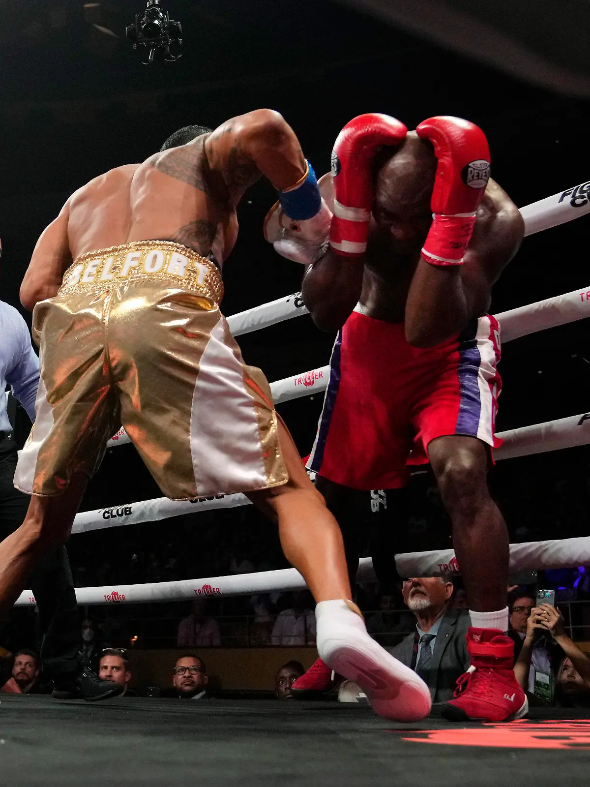 Former heavyweight champion Evander Holyfield, right, shields himself from punches by former MMA star Vitor Belfort, before the boxing bout was stopped in the first round Saturday, Sept. 11, 2021, in Hollywood, Fla. (AP Photo/Rebecca Blackwell)