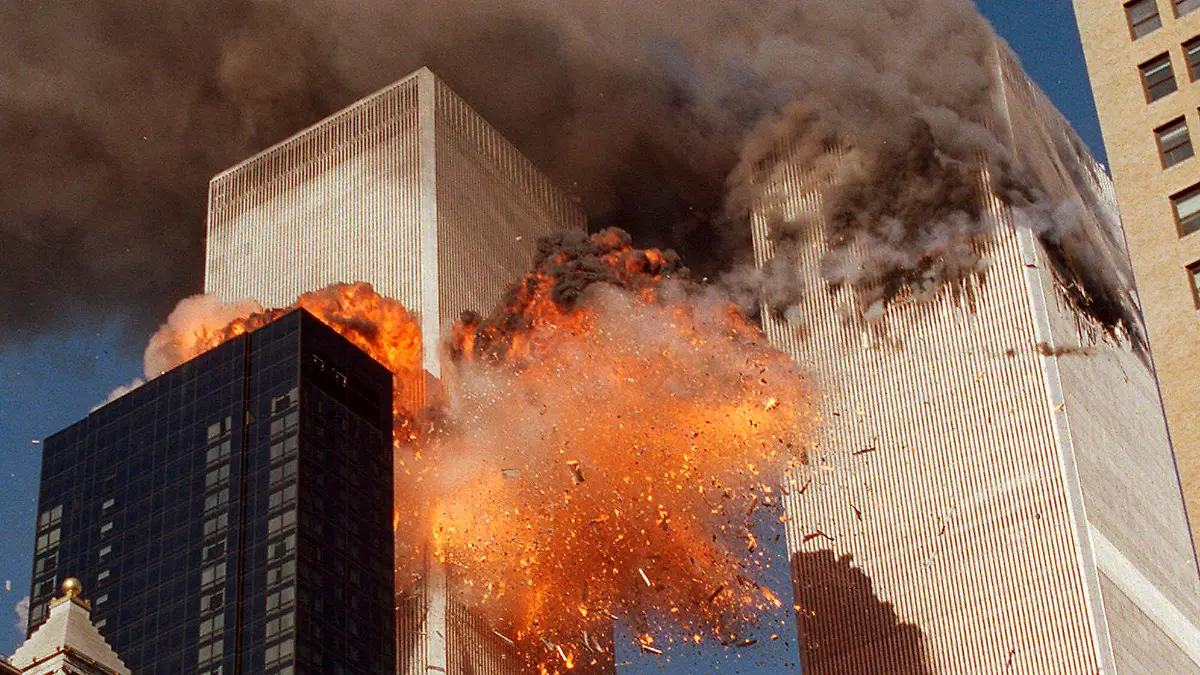FILE - In this Sept. 11, 2001, file photo, smoke billows from one of the towers of the World Trade Center and flames as debris explodes from the second tower in New York. Relatives of the victims of the Sept. 11 attacks called Thursday, Sept. 2, for the Justice Department's inspector general to investigate the FBI's failure to produce certain pieces of evidence from its investigation. (AP Photo/Chao Soi Cheong, File)