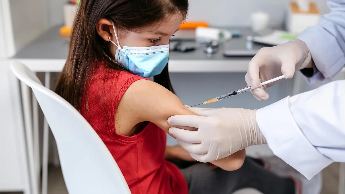 Little girl receiving coronavirus vaccine at doctor's office