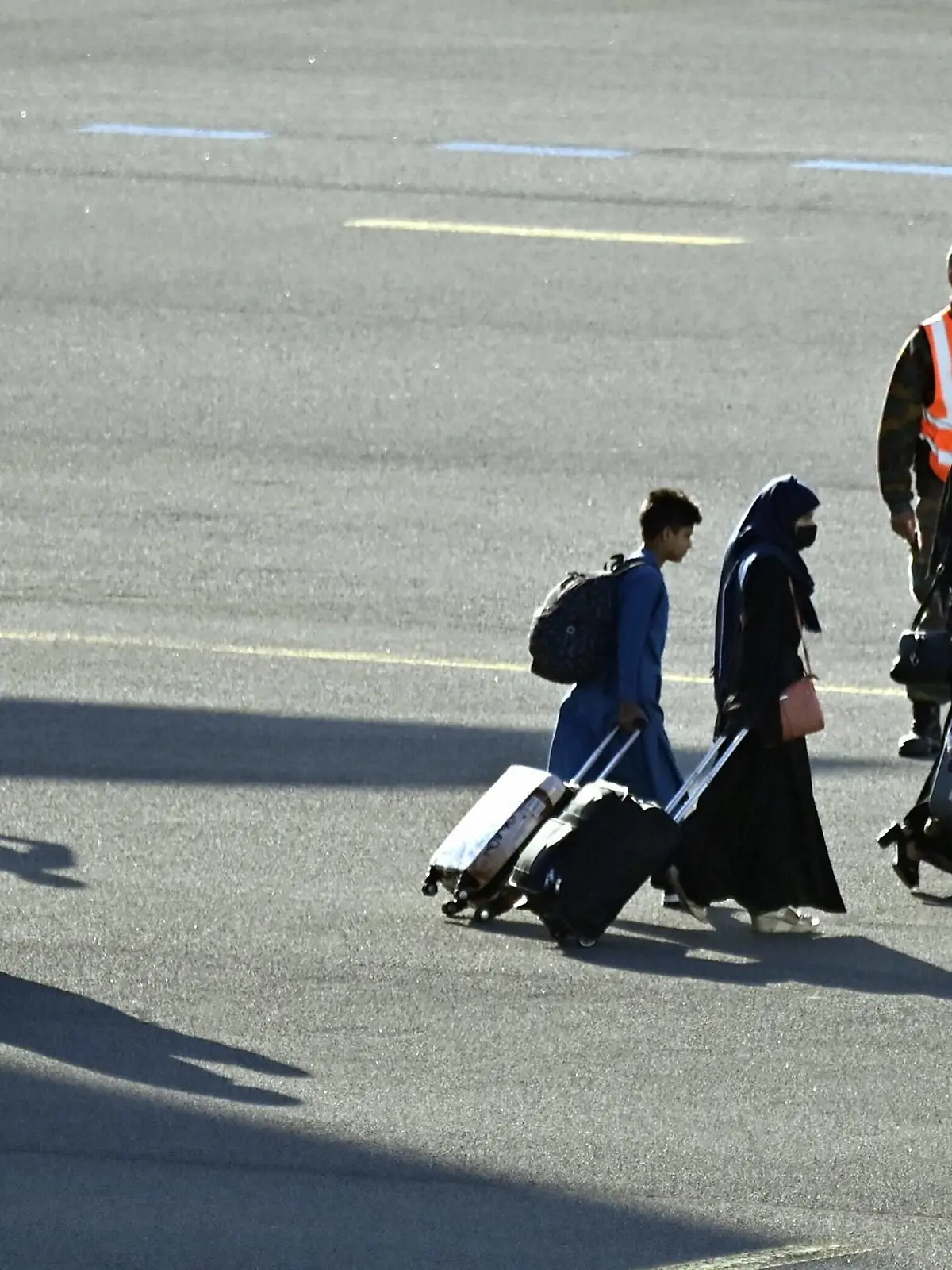  Illustration picture shows people going from the plane to the bus at the arrival of a chartered military airplane Airbus A330 MRTT carrying evacuated people from Afghanistan, at the military airport in Melsbroek, Wednesday 25 August 2021. The Belgian military evacuation mission Operation Red Kite flies defense cargo planes back and forth between the Pakistani capital Islamabad and Kabul in Afghanistan, to get Belgians and their families, but also Afghans such as interpreters, fixers and employees of human rights organizations safely out of Afghanistan. PUBLICATIONxINxGERxSUIxAUTxONLY ERICxLALMAND 3071431