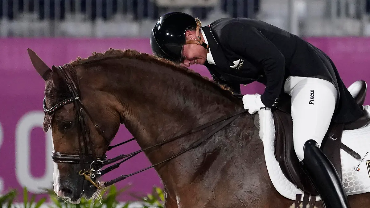 Germany's Isabell Werth, pats her horse, Bella Rose 2, after competing in the equestrian dressage individual final at the 2020 Summer Olympics, Wednesday, July 28, 2021, in Tokyo. (AP Photo/David Goldman)