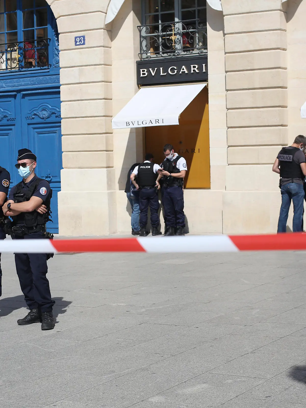 Police officers stand outside the Bulgari jewelry after they arrest two suspects following a Bulgari jewelry heist on the posh Place Vendome in Paris, Tuesday, Sept.7, 2021. One of the suspects was shot in the leg by an officer before being arrested. (AP Photo/Rafael Yaghobzadeh)