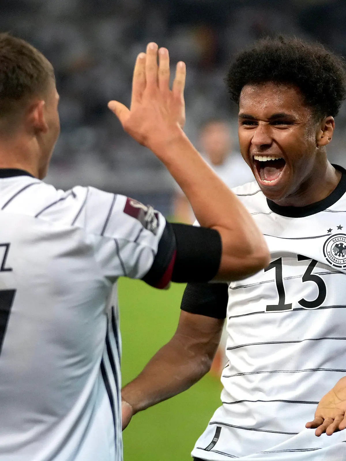 Germany's scorer Karim Adeyemi, right, and his teammate Florian Wirtz celebrate their side's sixth goal during the World Cup 2022 group J qualifying soccer match between Germany and Armenia at Mercedes-Benz Arena stadium in Stuttgart, Germany, Sunday, Sept. 5, 2021. (AP Photo/Matthias Schrader)