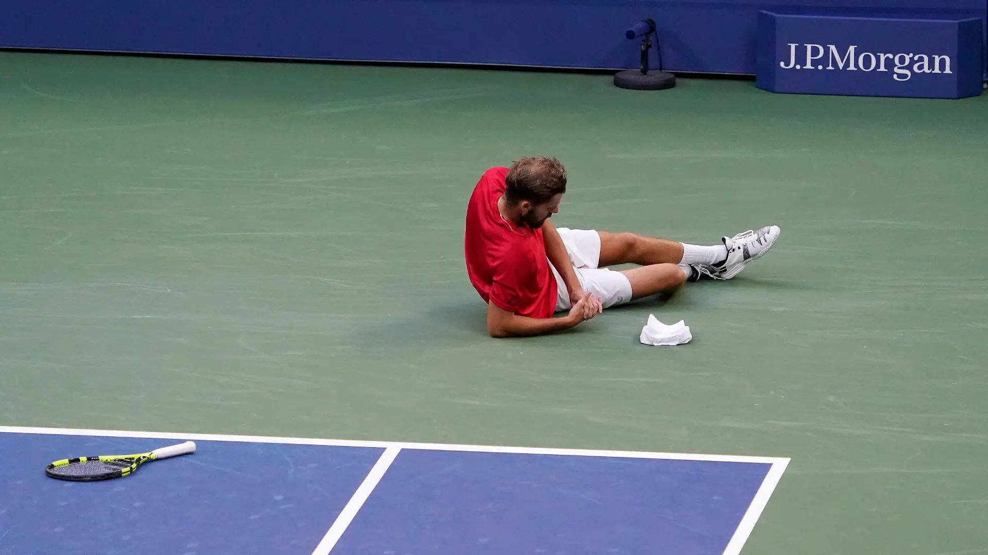 Oscar Otte, of Germany, falls as he plays against Matteo Berrettini, of Italy, during the fourth round of the US Open tennis championships, Monday, Sept. 6, 2021, in New York. (AP Photo/Elise Amendola)
