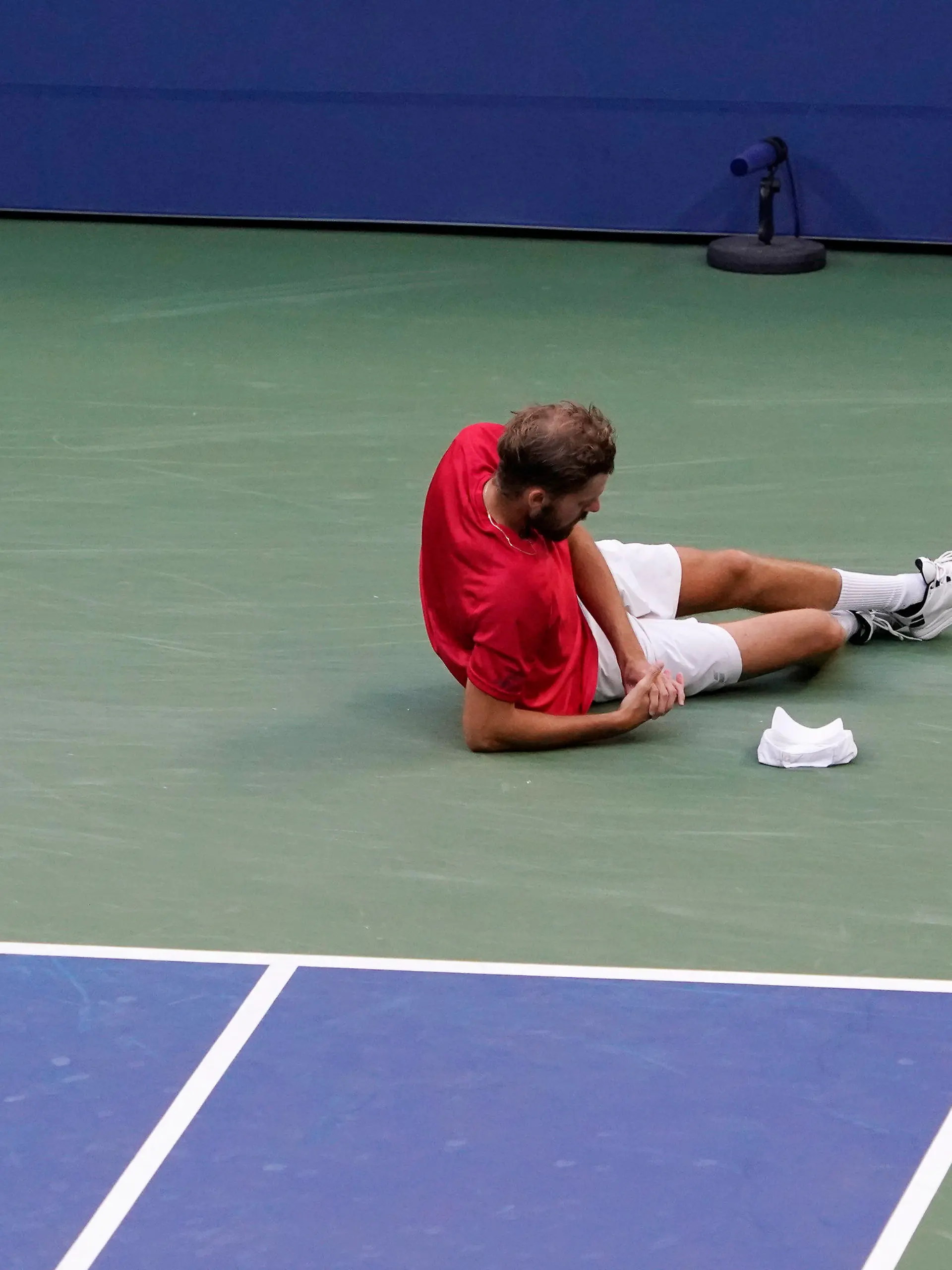 Oscar Otte, of Germany, falls as he plays against Matteo Berrettini, of Italy, during the fourth round of the US Open tennis championships, Monday, Sept. 6, 2021, in New York. (AP Photo/Elise Amendola)