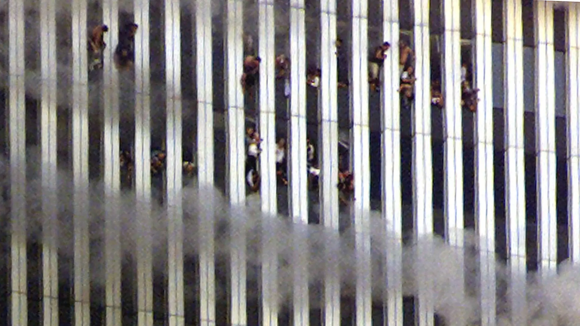 FILE PHOTO: People look out of the burning North tower of the World Trade Center in New York City, New York, U.S. September 11, 2001. REUTERS/Jeff Christensen/File Photo SEARCH "20TH ANNIVERSARY OF THE SEPTEMBER 11 ATTACKS" FOR THE PHOTOS