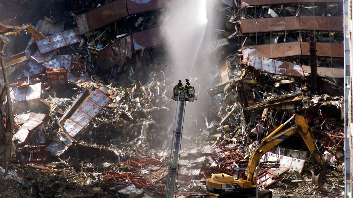 FILE PHOTO: New York City firefighters pour water on the wreckage of 7 World Trade Center in New York, U.S., early September 12, 2001. REUTERS/Mike Segar/File Photo SEARCH "20TH ANNIVERSARY OF THE SEPTEMBER 11 ATTACKS" FOR THE PHOTOS