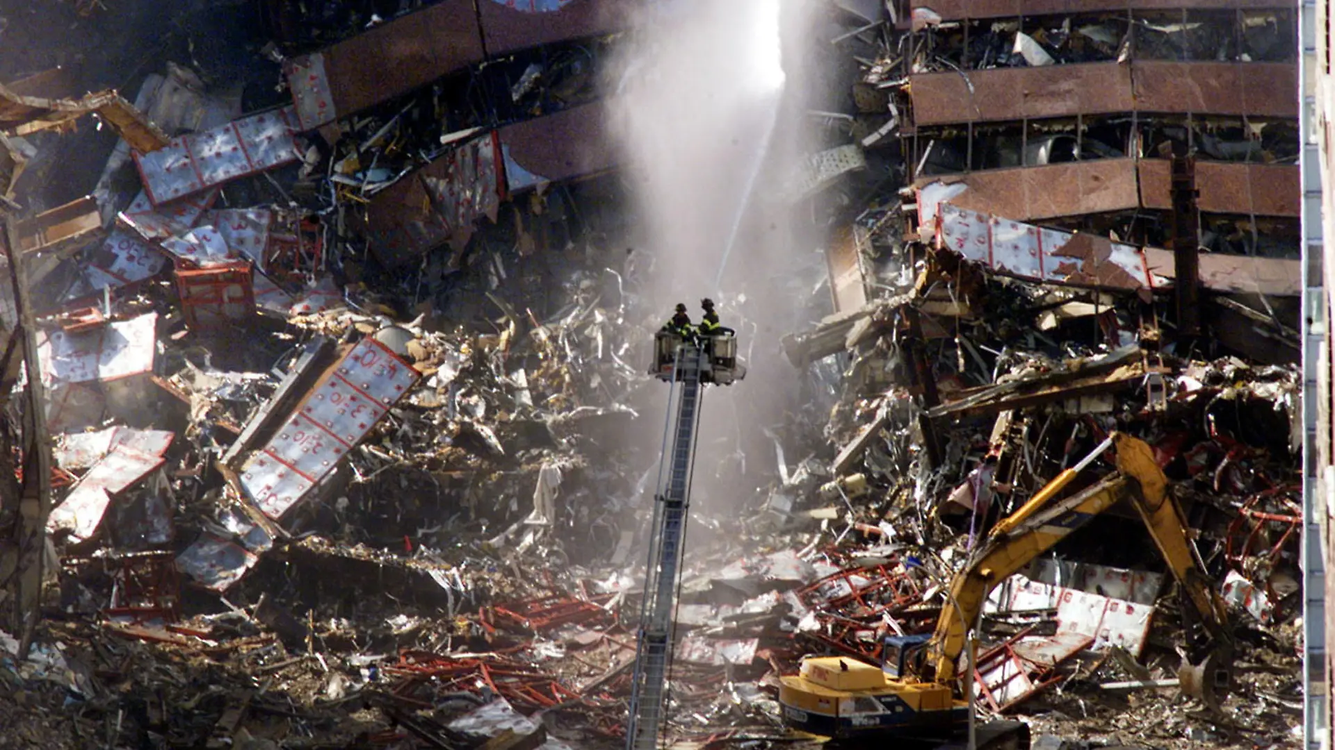 FILE PHOTO: New York City firefighters pour water on the wreckage of 7 World Trade Center in New York, U.S., early September 12, 2001. REUTERS/Mike Segar/File Photo SEARCH "20TH ANNIVERSARY OF THE SEPTEMBER 11 ATTACKS" FOR THE PHOTOS