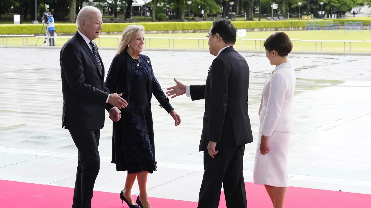 U.S. President Joe Biden, left, and first lady Jill Biden, second left, are welcomed by Japan's Prime Minister Fumio Kishida and his wife Yuko Kishida at the Peace Memorial Park during a visit as part of the G7 Hiroshima Summit in Hiroshima, western Japan Friday, May 19, 2023. (Franck Robichon/Pool Photo via AP)