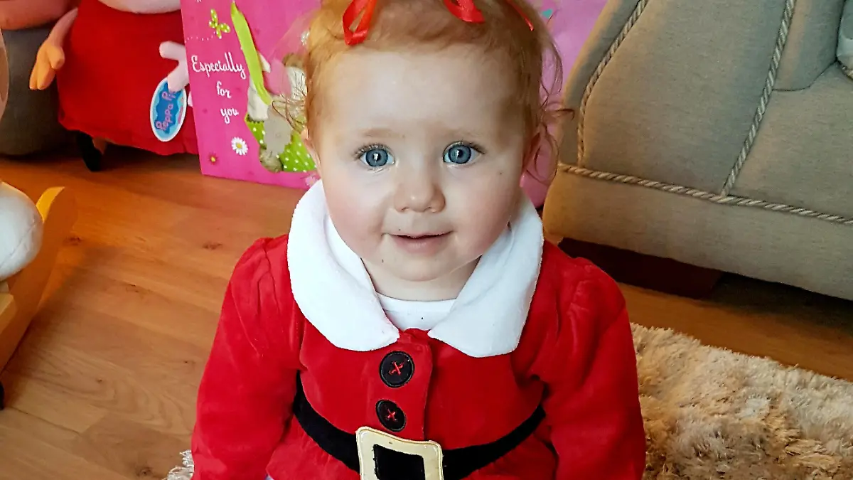 Baby Honey Rose Newbold celebrates her first birthday after defying medics who warned her parents she would probably die within hours of being born. See SWNS story SWHOSPICE; Meet a real festive miracle - a baby fought back to survive a risky Boxing Day heart op despite being sent to a hospice to die. Parents Kayley Newbold, 31, and Gary Clark, 34, were told Honey-Rose might only have hours to live after she was diagnosed with a life-threatening condition in the womb. But rather than the blue-skinned baby struggling to breathe that she was warned to expect, Honey-Rose was born pink and healthy-looking, and began to feed after she was born on December 19, 2016. However, the couple were told she would need hospice care - but as they sat beside her cot, they decided to fight for giving their daughter a chance at life and sought a second opinion.