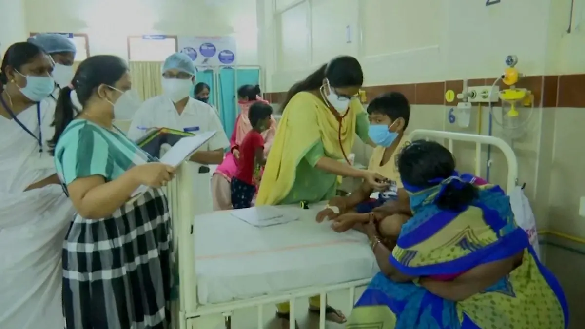 A doctor examines a young patient lying in a hospital bed at an Eluru hospital, after hundreds of people were hospitalised due to an unknown illness in the southern state of Andhra Pradesh, in this still frame taken from video dated December 9, 2020. ANI/Reuters TV/via REUTERS THIS IMAGE HAS BEEN SUPPLIED BY A THIRD PARTY.NO RESALES. NO ARCHIVES. INDIA OUT. FOR REUTERS CUSTOMERS ONLY.