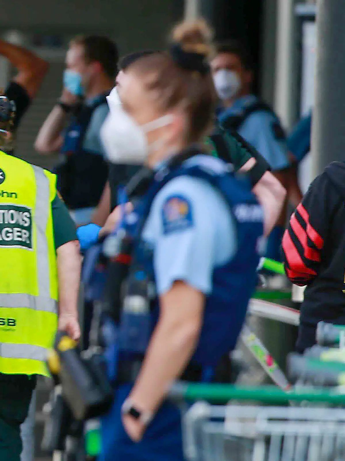 Police and ambulance staff attend a scene outside an Auckland supermarket, Friday, Sep. 3, 2021. New Zealand authorities say they shot and killed a violent extremist after he entered a supermarket and stabbed and injured six shoppers. Prime Minister Jacinda Ardern described Friday's incident as a terror attack. (Alex Burton/New Zealand Herald via AP)