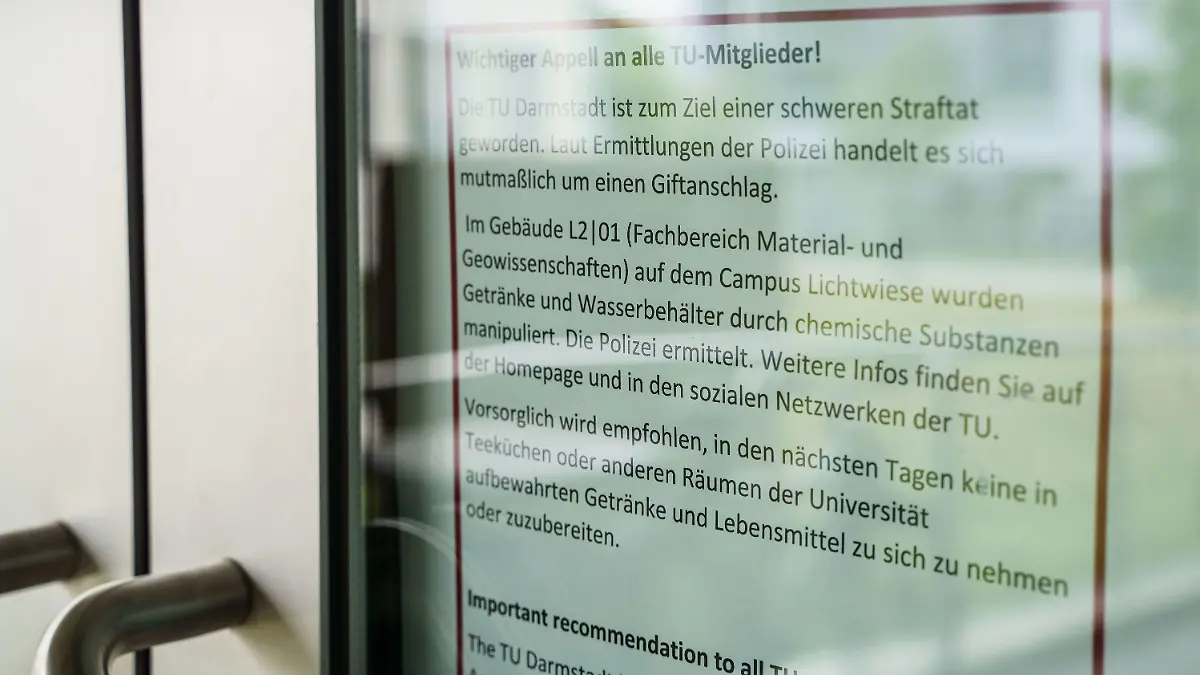 24.08.2021, Hessen, Darmstadt: Ein Blatt mit einem Appell der Technischen Universität Darmstadt an alle TU-Mitglieder hängt am Eingang zum Gebäude L201 auf dem Campus Lichtwiese. Am Tag zuvor waren hier sechs Menschen mit Vergiftungserscheinungen in Kliniken gebracht worden, ein 30 Jahre alter Student befand sich in einem kritischen Zustand. Wer die giftigen Stoffe in Lebensmitteln deponiert hat, ist unklar. Es wird wegen versuchten Mordes ermittelt. Foto: Frank Rumpenhorst/dpa +++ dpa-Bildfunk +++