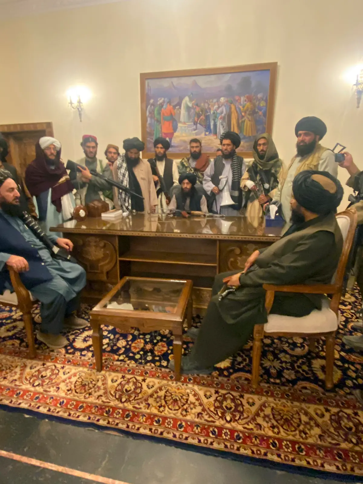 Taliban fighters take control of Afghan presidential palace after the Afghan President Ashraf Ghani fled the country, in Kabul, Afghanistan, Sunday, Aug. 15, 2021. (AP Photo/Zabi Karimi)