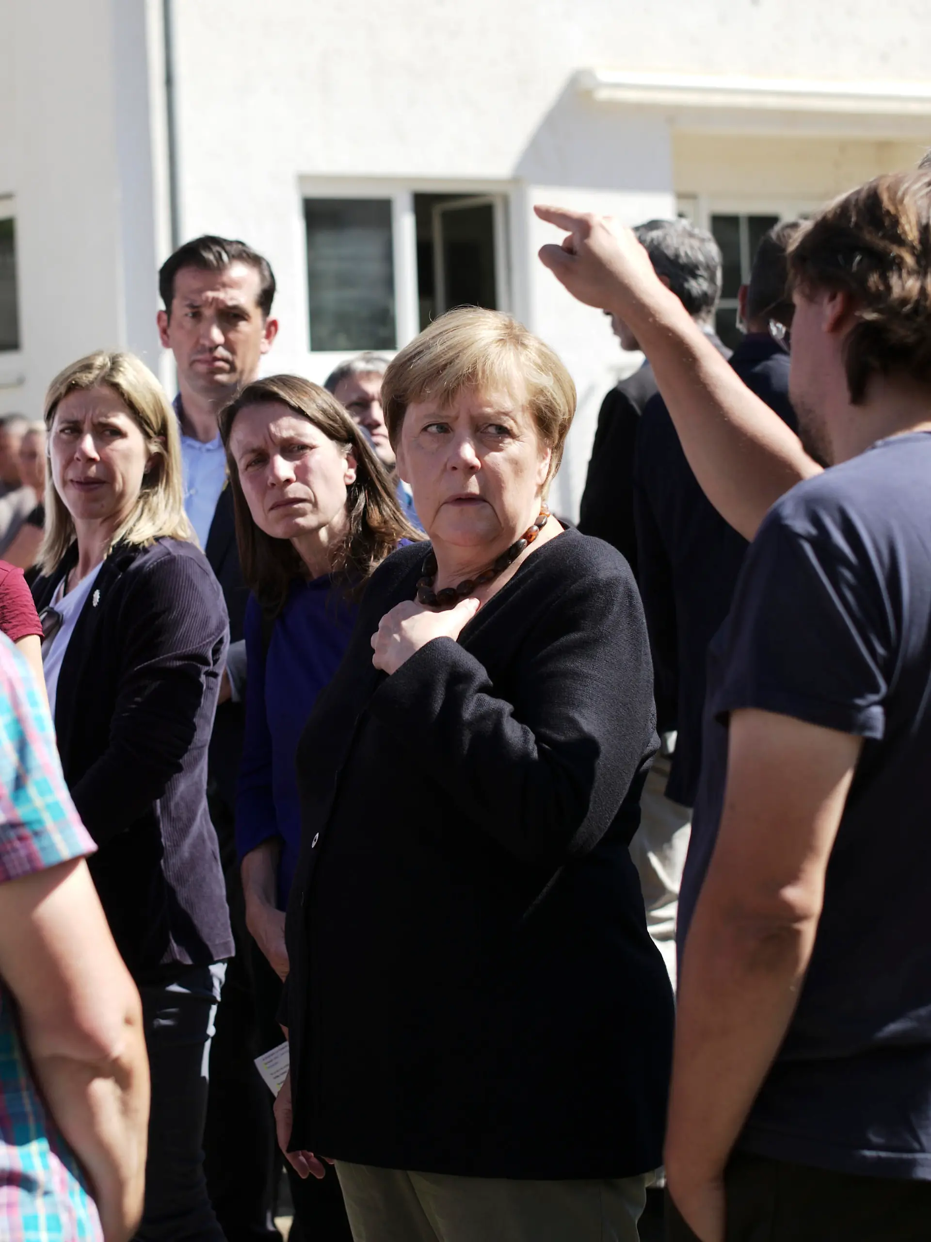 German Chancellor Angela Merkel talk to residents during her visit visit in the flood-damaged city Altenahr, Germany, Friday, Sept. 3, 2021. After days of extreme downpours causing devastating floods hit the valley of the river Ahr in July. (AP Photo/Markus Schreiber, Pool)