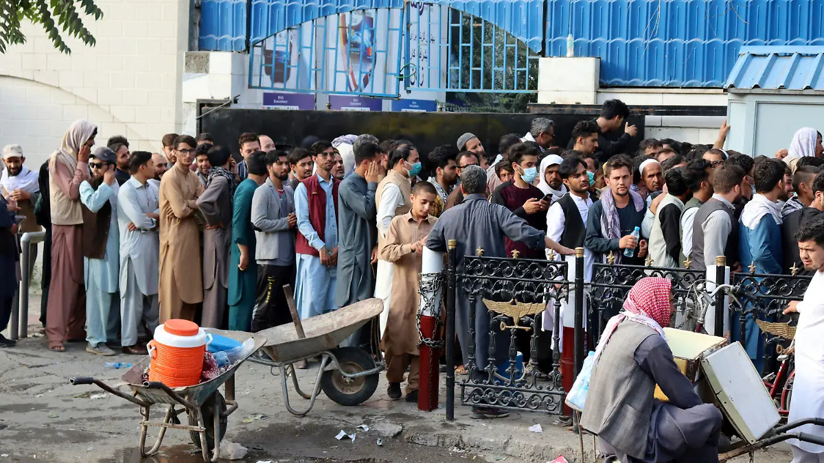 Afghans wait in long lines for hours to try to withdraw money, in front of a bank in Kabul, Afghanistan, Monday, Aug. 30, 2021. The Taliban have limited weekly withdrawals to $200. (AP Photo/Khwaja Tawfiq Sediqi)