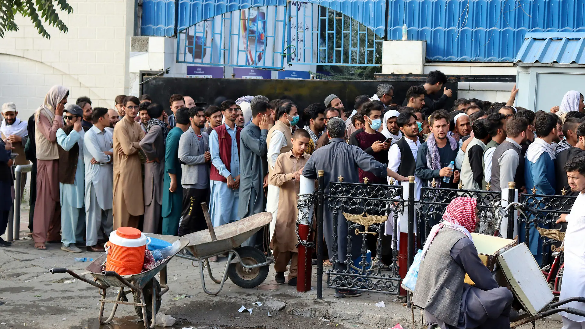 Afghans wait in long lines for hours to try to withdraw money, in front of a bank in Kabul, Afghanistan, Monday, Aug. 30, 2021. The Taliban have limited weekly withdrawals to $200. (AP Photo/Khwaja Tawfiq Sediqi)