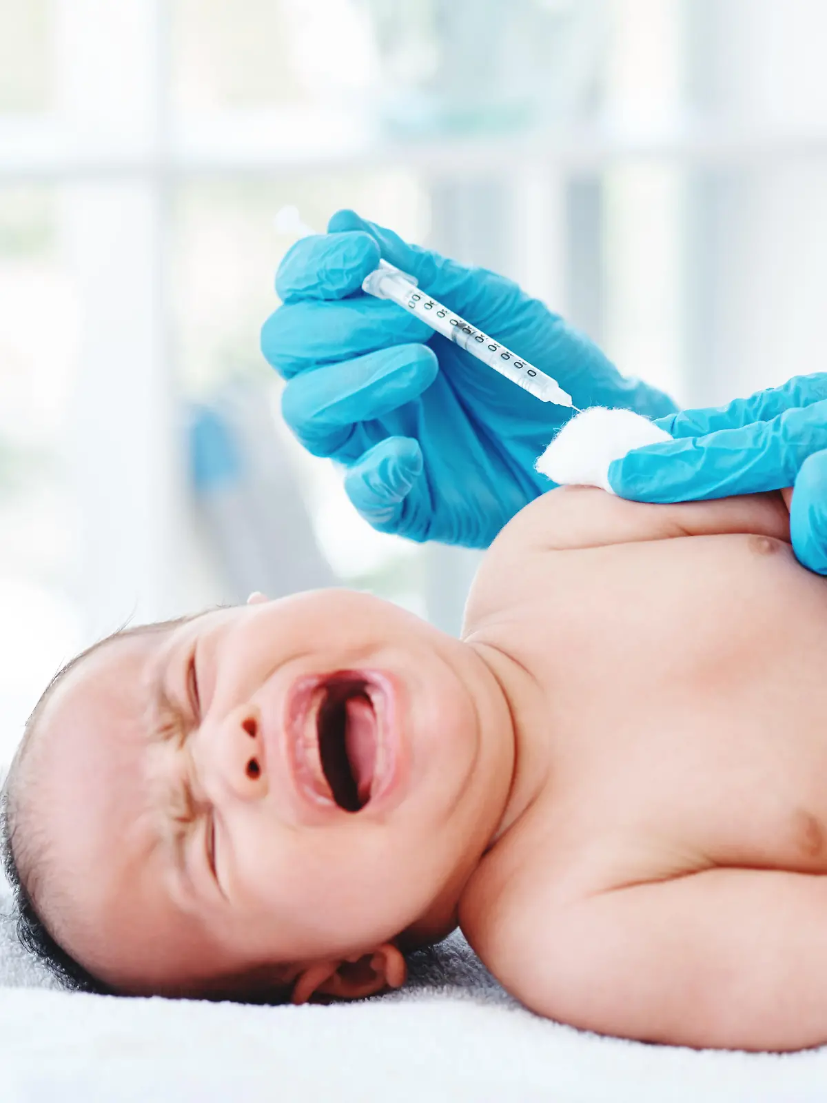 Cropped shot of a doctor giving a newborn baby boy an injection