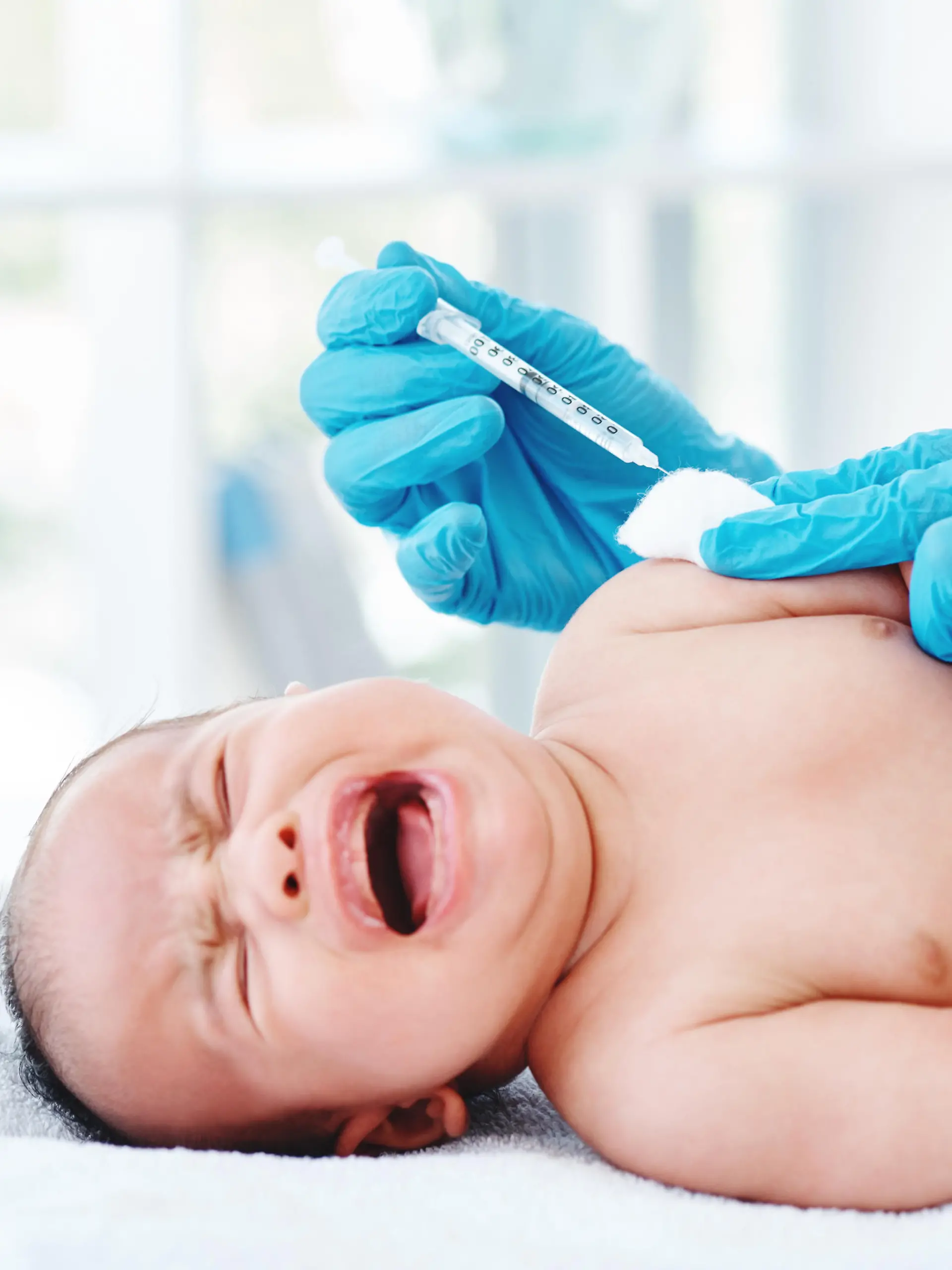 Cropped shot of a doctor giving a newborn baby boy an injection