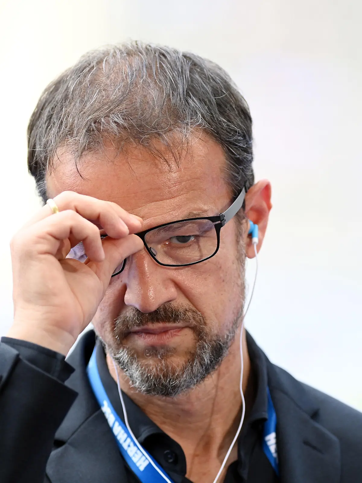 21.08.2021, Berlin: Fußball: Bundesliga, Hertha BSC - VfL Wolfsburg, 2. Spieltag im Olympiastadion. Fredi Bobic, Geschäftsführer Sport von Hertha BSC, greift sich vor dem Interview an die Brille. Foto: Soeren Stache/dpa-Zentralbild/dpa - WICHTIGER HINWEIS: Gemäß den Vorgaben der DFL Deutsche Fußball Liga bzw. des DFB Deutscher Fußball-Bund ist es untersagt, in dem Stadion und/oder vom Spiel angefertigte Fotoaufnahmen in Form von Sequenzbildern und/oder videoähnlichen Fotostrecken zu verwerten bzw. verwerten zu lassen. +++ dpa-Bildfunk +++