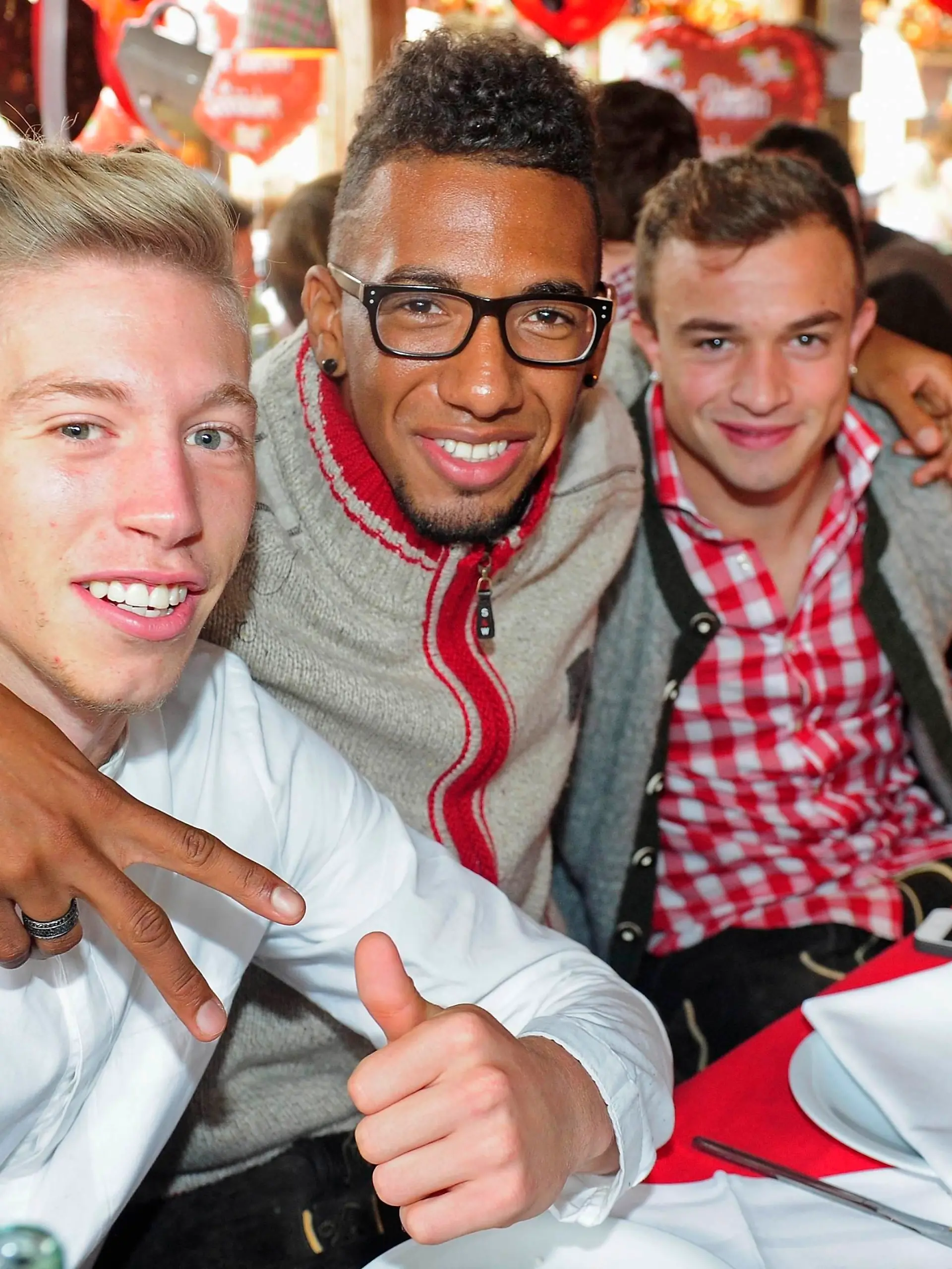 Bayern Munich's Mitchell Weiser (L-R), Jerome Boateng and Xherdan Shaqiri pose at the Oktoberfest in Munich October 6, 2013. REUTERS/Alexander Hassenstein/Pool (GERMANY - Tags: SPORT SOCCER SOCIETY ENTERTAINMENT)